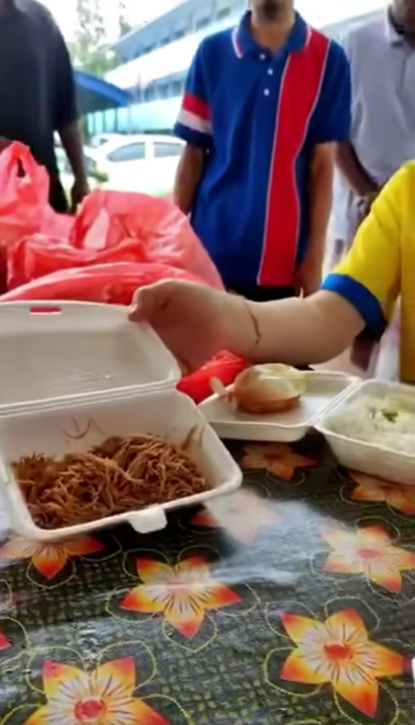 Wee Ka Siong showing the meager portions provided to flood victims.