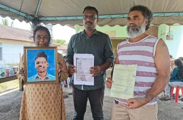 Chantren (right) and his family members show documents, while his wife holds a photo frame of their son.