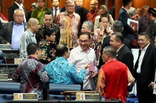 Anwar mingles with MPs after his speech in Dewan Rakyat yesterday, 9 March.