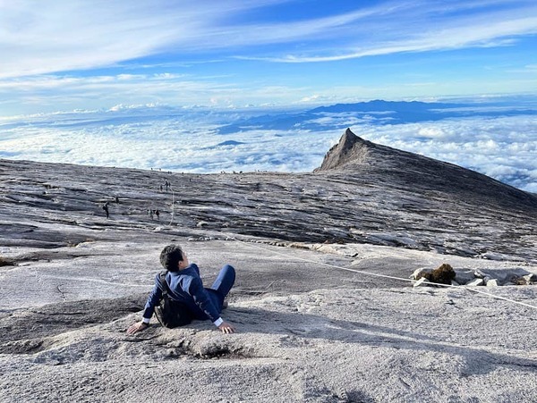 Sada sitting at the side of Mount Kinabalu.