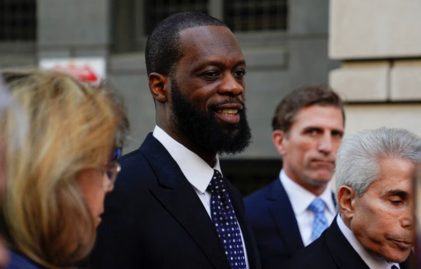 Prakazrel "Pras" Michel of the hip hop group, The Fugees, leaving US federal court with his attorneys after being convicted on criminal charges.