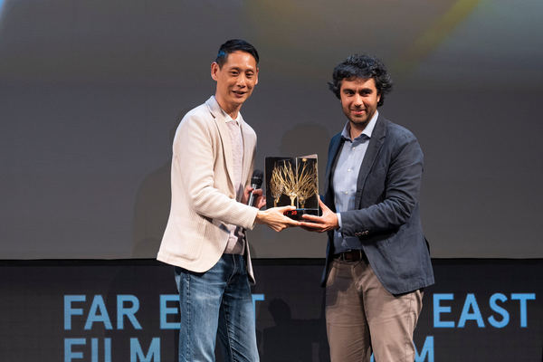 'Abang Adik' director Jin Ong (left) receiving the Golden Mulberry Audience Award in the 25th Far East Film Festival (FEFF).