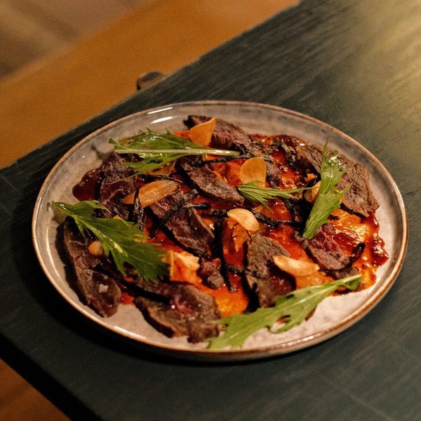 Beef Tataki with kimchi, mustard, and seaweed.