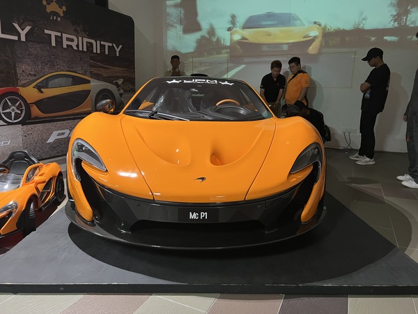 One of the hybrid hypercars, the McLaren P1 in Volcano Orange.