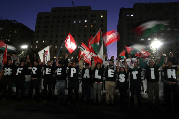 Demonstrators gather to express support for Palestinians in front of the La Moneda Palace in Santiago, Chile on 11 October.