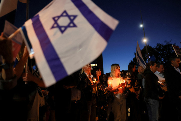 People hold candles during a demonstration organised by the Switzerland-Israel Association against the attacks by Hamas, outside the United Nations in Geneva, Switzerland on 11 October.