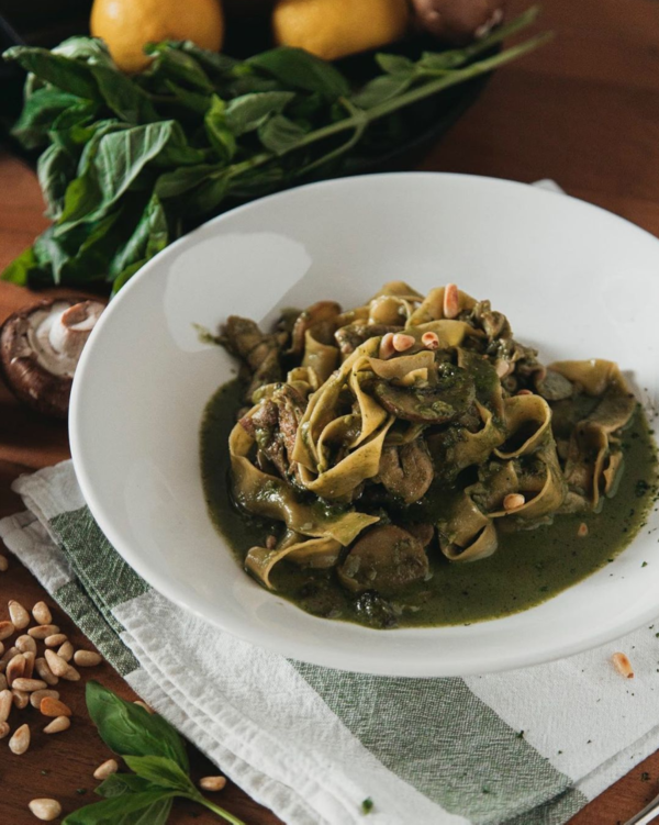 Handmade Tagliatelle with Spinach Basil Pesto Sauce topped with Pine Nuts (Vegetarian).