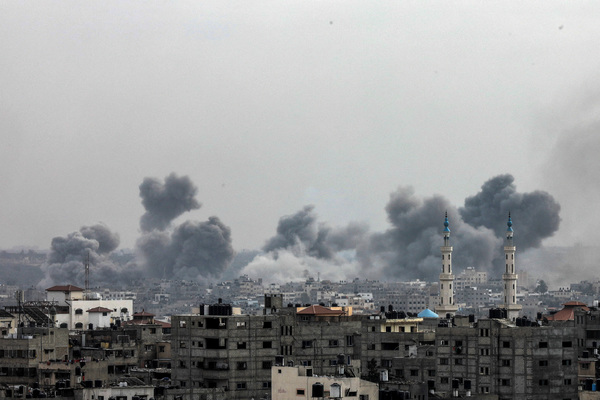 Plumes of smoke rise during Israeli strikes in Gaza City on 29 October.