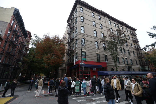 People gather near a makeshift memorial for actor Matthew Perry.