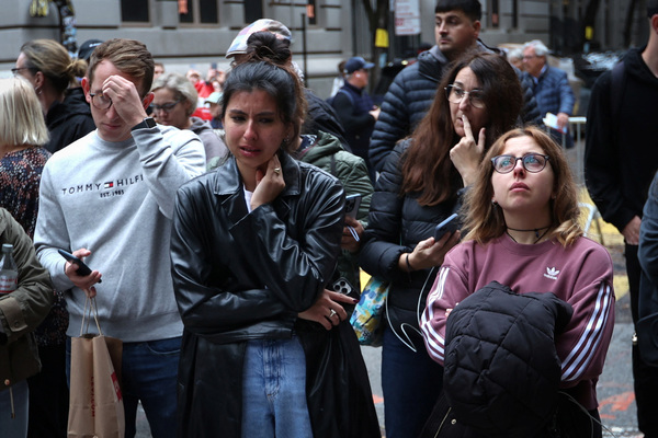 People gather near a makeshift memorial for actor Matthew Perry.