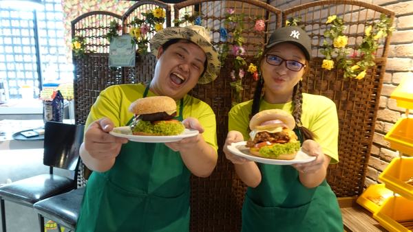 DIB staff proudly showing their Juicy Jumbo Burgers.