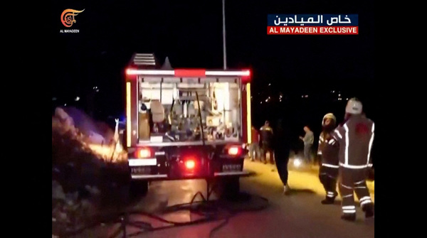 Footage from Al-Mayadeen TV shows emergency teams working at the scene where Hezbollah says an Israeli strike killed three children, in southern Lebanon, on 5 November.