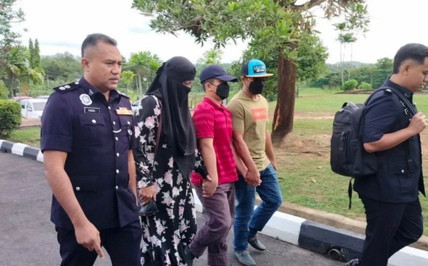 The teenager (third from the left) appearing in court on Sunday, 3 November.