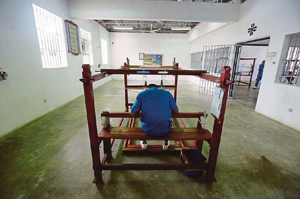 An inmate engrossed in working at a loom in Bentong Prison.