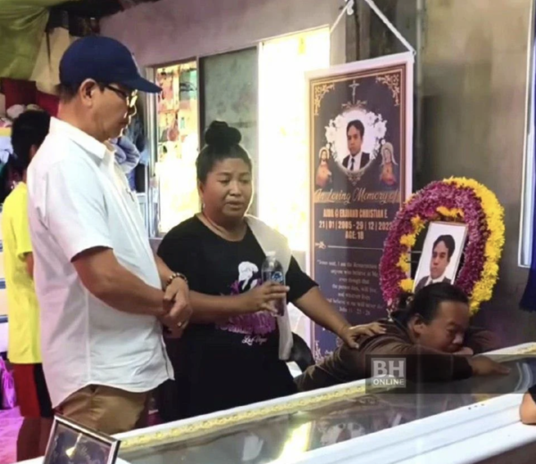 Tuaran MP Datuk Seri Wilfred Madius Tangau paying his last respects to Aidil at his home in Kampung Buleing, Tamparuli.