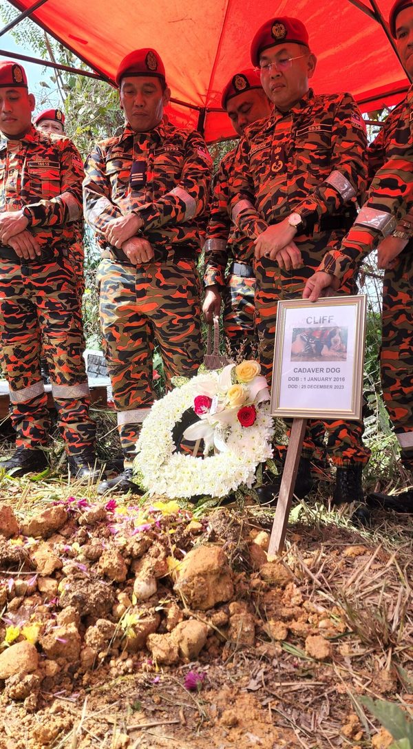 Steven (second from left), Khirudin, (third from left) and other firefighters sharing a moment of silence to honour Cliff at his funeral yesterday, 4 January.