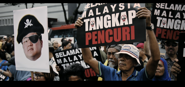 A protestor holding up a caricature of Jho Low in Malaysia.