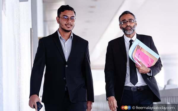 Mohd Khairi Anwar (left) with defence counsel N. Surendran.