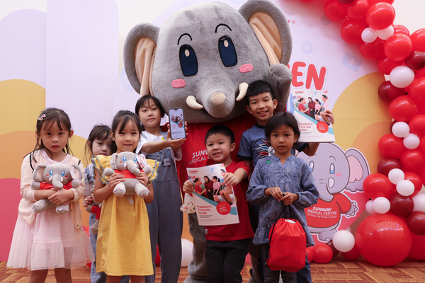 Children from SunMed Kid's Club with Elfy, the club's mascot.