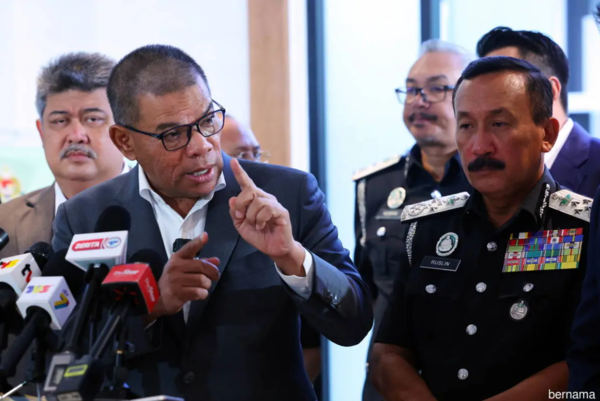 Home Minister Datuk Seri Saifuddin Nasution Ismail (left) at the opening of the Shaftsbury passport office in Putrajaya. With him is Immigration director general Datuk Ruslin Jusoh (right).