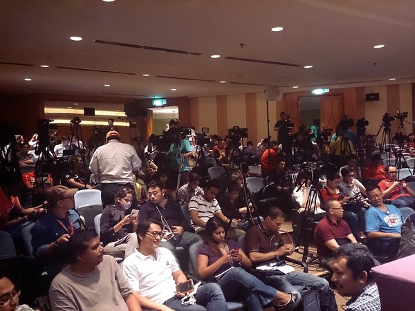 Local and foreign journalists eagerly await the first press briefing on MH370's disappearance inside the packed auditorium at Sama Sama Hotel.