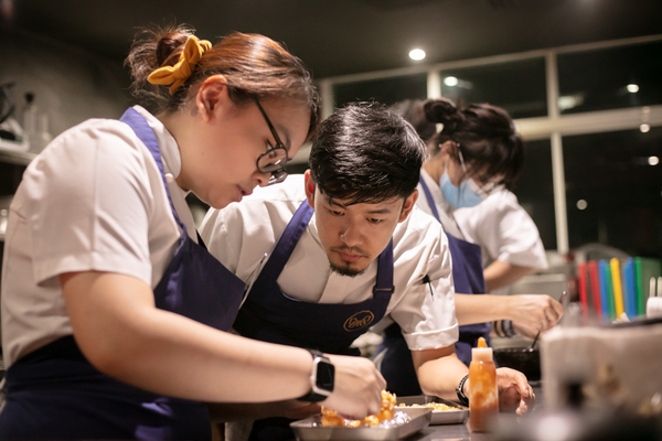 Goh is seen in action in the kitchen.