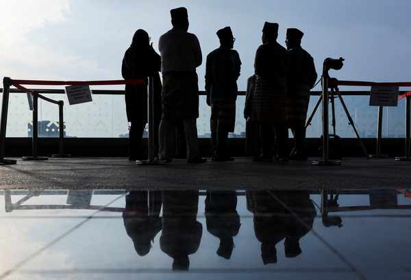 Silhouettes of Malaysian Islamic Development Department officers and a telescope which they use to perform'rukyah', the sighting of the new moon that signals the start of the holy month of Ramadan, in Putrajaya.