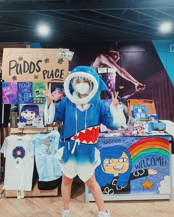 Pudds shows off her booth at the Nijigen Expo in Sungei Wang in 2022.