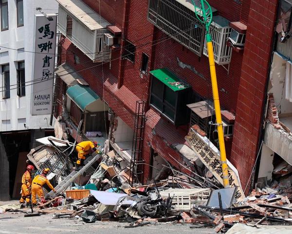 Military personnel searching for survivors in a damaged building in Hualien.