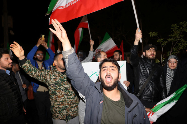 Iranian demonstrators react after the Islamic Revolutionary Guard Corps attack on Israel, during an anti-Israeli gathering in front of the British Embassy in Tehran, Iran, on 14 April.