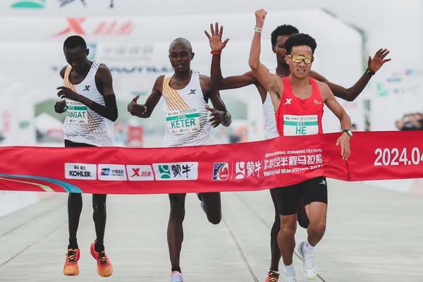 The African runners appear to let China's He Jie win the Beijing Half Marathon on Sunday, 14 April.