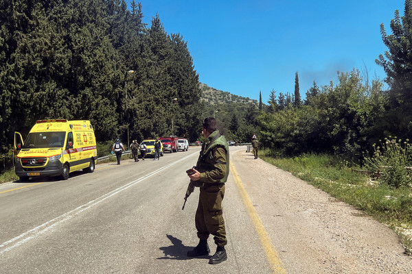 An Israeli soldier looks on at a scene, after it was reported that people were injured, amid ongoing cross-border hostilities between Hezbollah and Israeli forces, near Arab al-Aramashe in northern Israel.