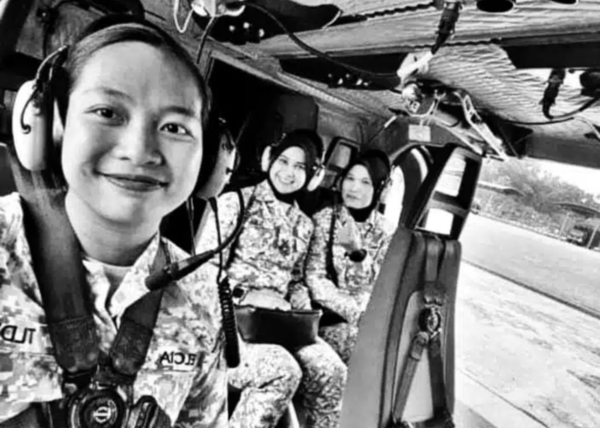 File photo of Joanna (left) along with two other Navy personnel in an aircraft.