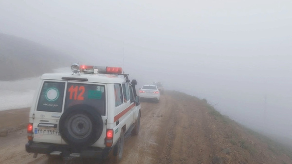 An ambulance and other vehicles drive on a foggy road following a crash of a helicopter carrying Iran's President Ebrahim Raisi, in Varzaqan, East Azerbaijan Province, Iran.