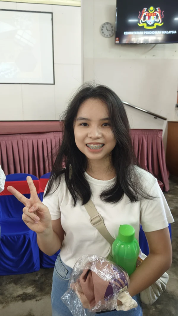 Huang is all smiles after receiving an A- in Chinese.