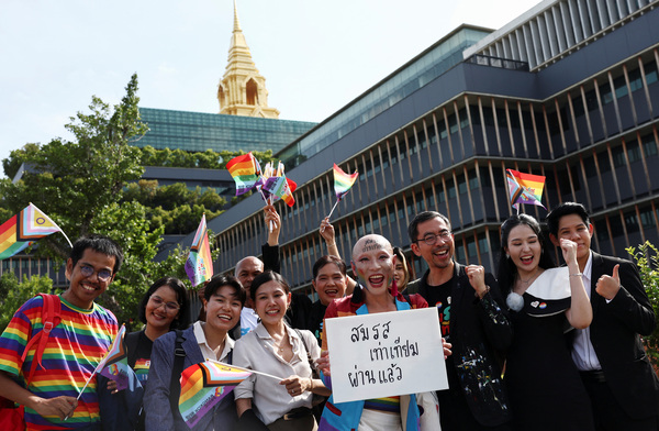 Members of the LGBTQ+ community celebrate after the passing of the marriage equality bill in its second and third readings by the Senate in Bangkok, Thailand, on 18 June.