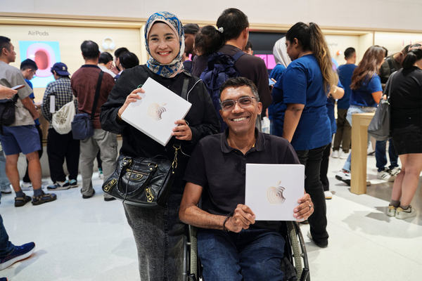 Customers show off their schwag at the opening of Apple The Exchange TRX.