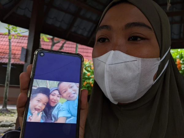 Nurain Hasnorizal showing a photo of her two sons.