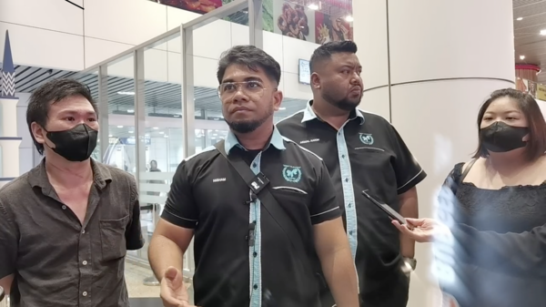 The victim, Law (first from right), with Malaysia International Humanitarian Organisation (MHO) secretary-general Datuk Hishamuddin Hashim (second from right) at Kuala Lumpur International Airport on Tuesday, 9 July.