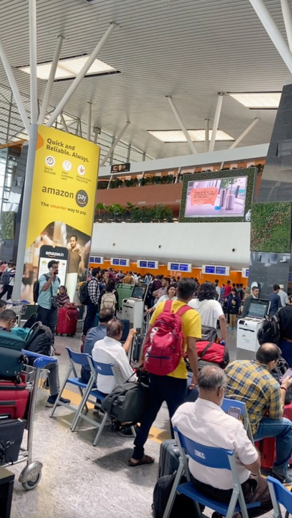 People wait for their flights as Indian airlines are affected by global IT outage in Bangalore, India on 19 July.