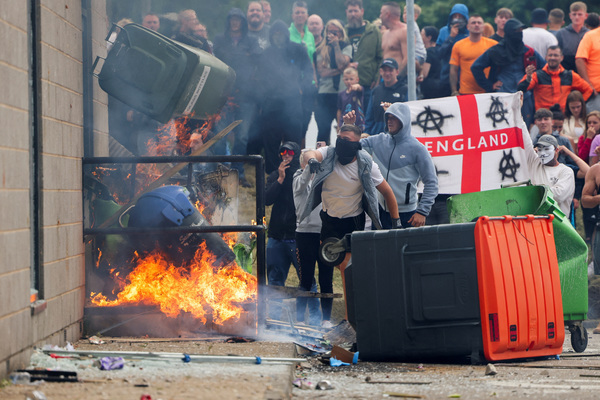 Protestors setting garbage bins on fire outside a hotel in Rotherham, Britain on 4 August.