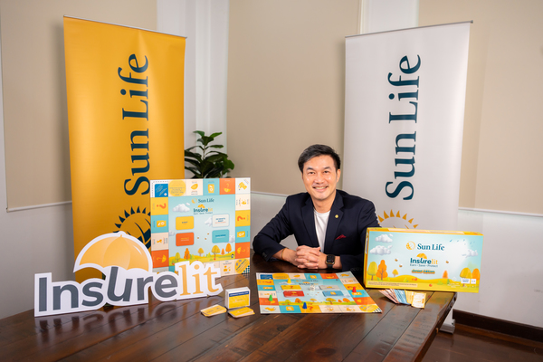 Sun Life Malaysia's chief executive officer and country head Raymond Lew with the InsureLit board games.