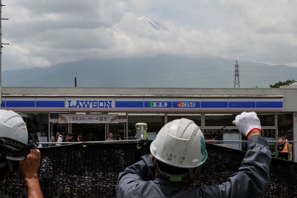 Photo taken 21 May of tourists standing nearby as workers erect a barrier to block the popular photo spot.