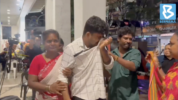 Vijaya's eldest son, 26-year-old Surya (in white), was visibly distraught on Friday evening, 23 August.