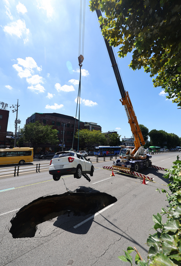 The car was lifted out of the sinkhole via crane.