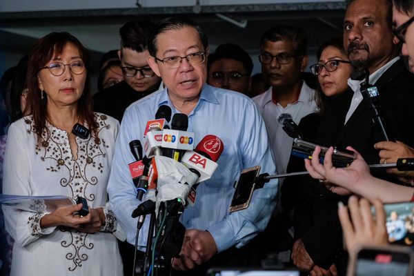 Left to right: Teresa Kok and Lim Guan Eng speaking to reporters at the police headquarters in Bukit Aman yesterday, 10 September.