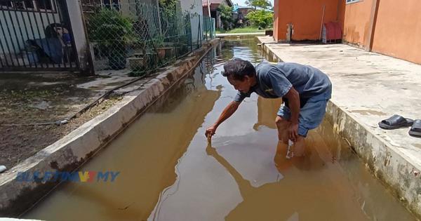 A villager, Yahmin Sairin, showing the drain where the body of the 2-year-old girl was found.