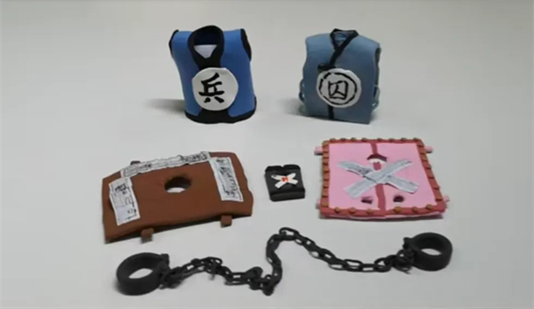 Miniature models of prisoner and guard costumes and restraints.