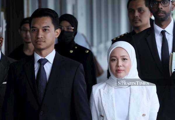 FashionValet founders Datin Vivy Yusof and Datuk Fadzarudin Shah Anuar arrive at the Kuala Lumpur Sessions Court today, 5 December.