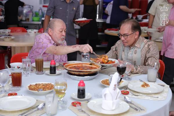 His Majesty Sultan Ibrahim, the King of Malaysia, serving asam pedas to prime minister Datuk Seri Anwar Ibrahim.